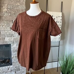 Cute brown t-shirt with splatter like patter at top.